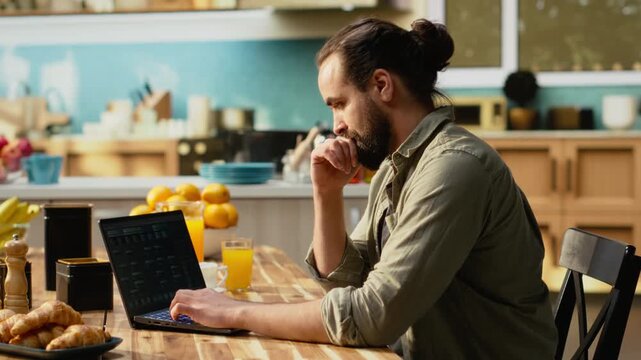 Man focused on programming and software development tasks. Laptop screen displays code, scripts and binary data, illustrating system maintenance and remote work in a high-tech occupation.