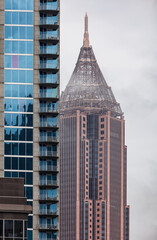 View of the Downtown Atlanta Skyline Cityscape showing several prominent buildings, and hotels on a cloudy afternoon.