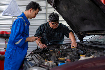 Fototapeta premium Auto mechanics checking car engine during maintenance service