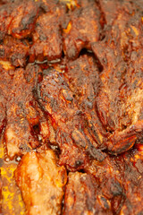 Roasted Beef Short Ribs with Caramelized Surface in an Oven Tray dark brown color with visible charring