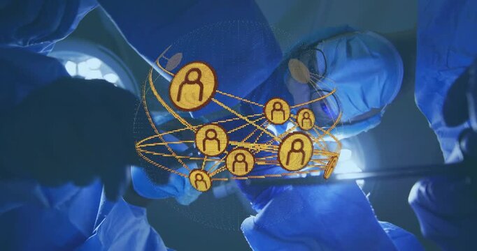 Surgeons raising hand passing tools rotating gold sphere showing nodes over patient guiding surgery