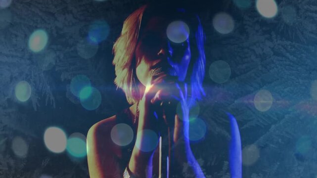 Female singer bringing mic closer, singing as cam shifting and revealing face, bokeh and lens flare