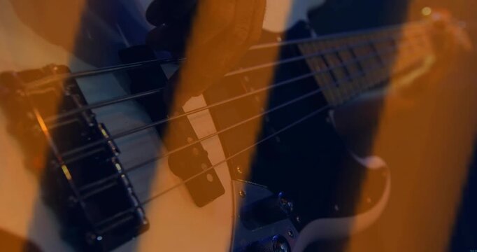 Male guitarist starting music riff as orange wave overlay sweeping across shot showing pickups