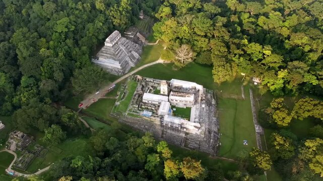 Aerial drone view of Palenque Mayan ruins featuring ancient pyramids and temples surrounded by tropical jungle in southern Mexico