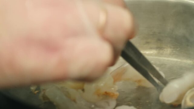 Cooking big shrimps and mussel seafood on frying pan. Preparation langoustines. Closeup. Top view. Vertical footage