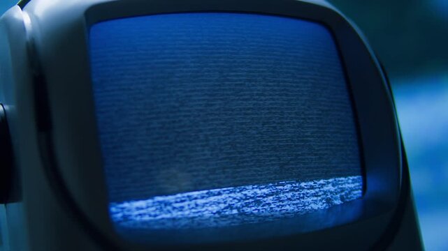 Retro TV, vintage television In a nostalgic setup, a retro TV displays grain on screen, scary halloween night device good for chroma key and green screen.