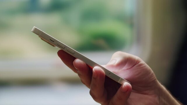 Man tourist using smartphone with green screen while traveling by train or bus, travelling application, male working during business travel. 