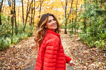 Happy, portrait and woman in nature in Autumn with adventure, holiday or weekend trip outdoor. Smile, walking and female person on vacation in woods, forest or park for break with positive attitude.