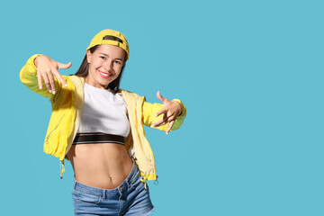 Female hip-hop dancer on blue background