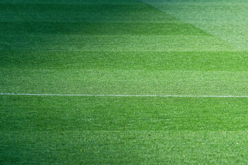 Obraz premium Well-Maintained Football Pitch with Striped Grass Pattern