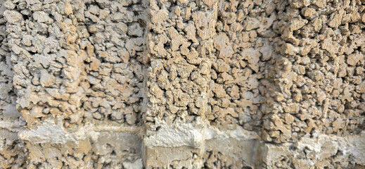 Rough surface of a concrete block wall forming an abstract background texture © FlorianSchultze