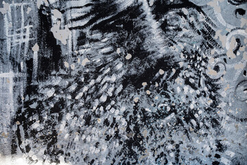 Abstract black and gray painted wall texture with layered brush strokes, scratches and splatter marks, distressed street art surface forming a gritty monochrome pattern with heavy detail closeup grit © Masarik