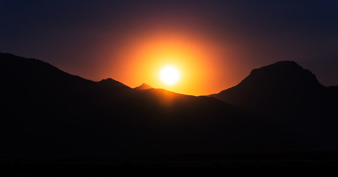 Sunset Over Mountain Peaks in Wyoming with Dramatic Silhouette Landscape