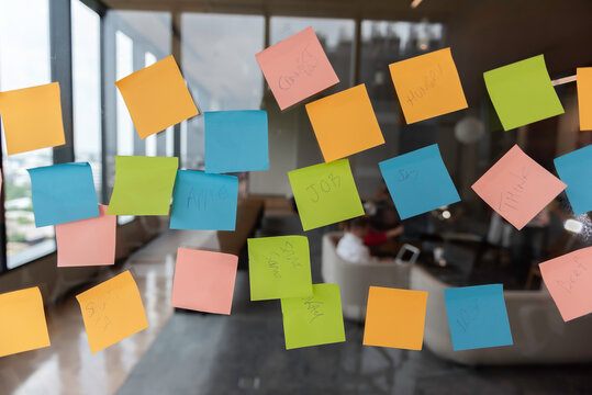 Sticky Note Post It Board Office. Business people meeting at office and use post it notes to share idea. Brainstorming concept. Sticky note on glass wall or blackboard. Set of colorful blank notes.
