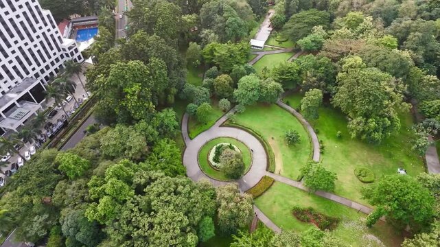 Aerial bird's-eye orbit shot of a circular public park design in Jakarta