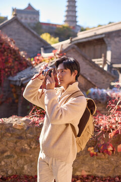 Happy man capturing memories on his trip