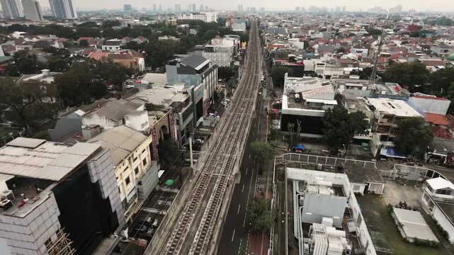 Aerial bird's-eye view of MRT Jakarta train moving forward on elevated tracks