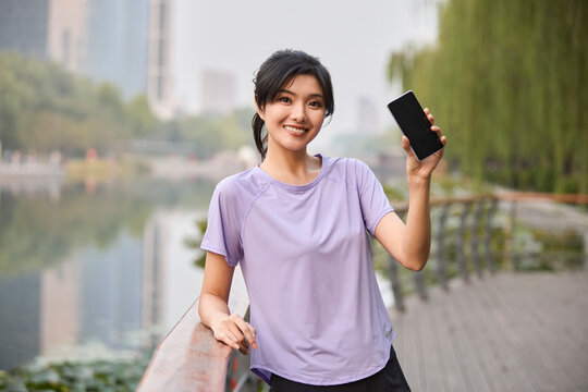 Happy young woman exercises outside