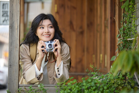 Happy young woman travels in Beijing