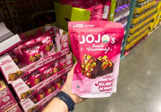 Jojo&rsquo;s Snack Raspberry Pistachio Almond Chocolate Bites Bag Held In Hand In Costco Store Aisle
