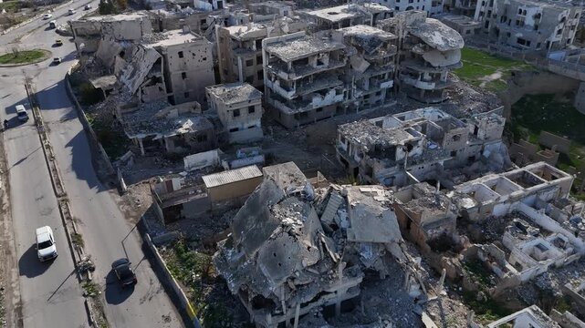 aerial drone shot of devastated buildings and rubble in the Jobar district of Damascus, documenting the aftermath of the Syrian war conflict.