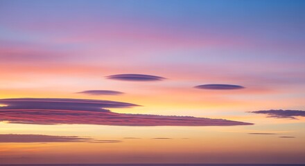 Fototapeta premium Vibrant sunset unfolds with breathtaking colorful clouds floating across the serene evening sky