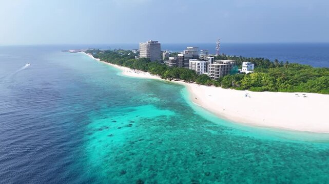 Aerial view of Ukulhas island, Maldives, showing new hotel construction along the pristine sunset beach. A perfect blend of tropical nature and developing tourism infrastructure.