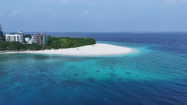 Aerial landscape of a remote white sand beach and the deep blue ocean in Ukulhas, Maldives.