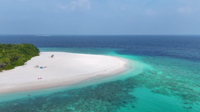 Stunning drone shot of a tropical paradise beach with white sand and clear blue water in Ukulhas, Maldives.