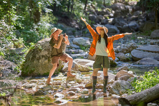 Happy couple enjoying themselves by the stream