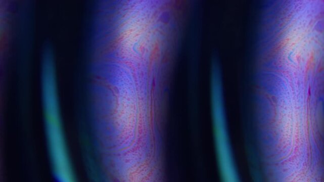 Defocused paint pour. Gasoline art. Blue purple orange color wet bubble neon curve flow liquid floating on abstract acrylic black background.
