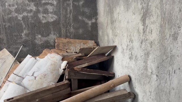 Scattered debris and wooden planks in a messy warehouse interior