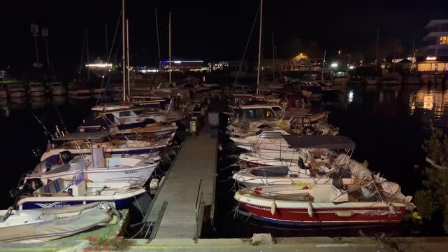 Boats parking in Atakoy Marina at night in Istanbul, Turkey. (4K video)