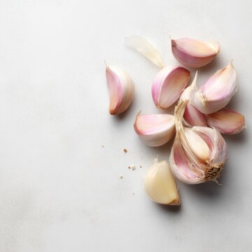 Flat lay composition with garlic cloves on light background