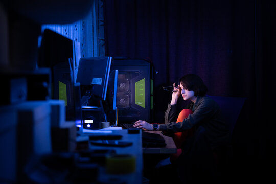 Tired woman rubbing eyes at her desk, depicting burnout and the struggle of creative writing deadlines.
