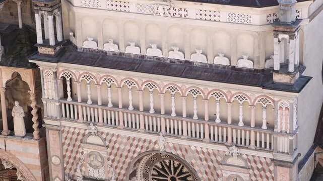 Close-up of the intricate marble carvings and rose window on the facade of the Colleoni Chapel in Bergamo Alta