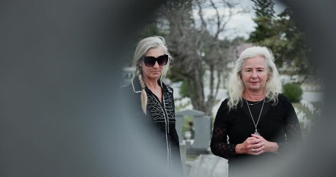 Senior, women and funeral at cemetery with vignette, death and talk for remembrance outdoor. Elderly people, friends or grief at graveyard for memorial service, sad or circle frame at burial ceremony