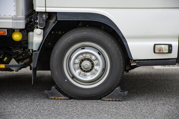 輪留めを設置して停車しているトラックのタイヤ