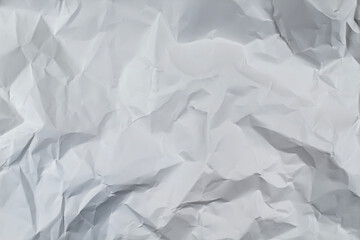 Obraz premium White crumpled paper texture background with wrinkled folds and shadows