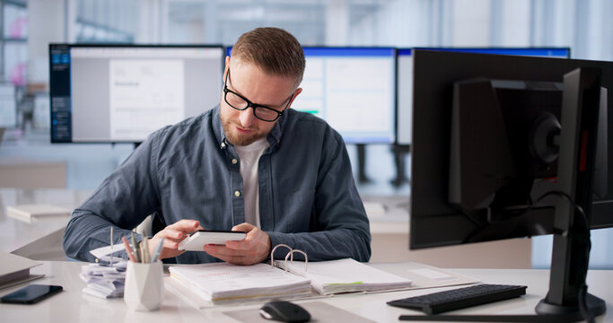 Billing Specialist Analyzes Multiple Screens