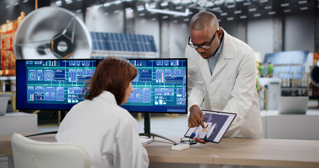 An African Engineer And Scientist Use Computers To Design Satellite Parts © Andrey Popov