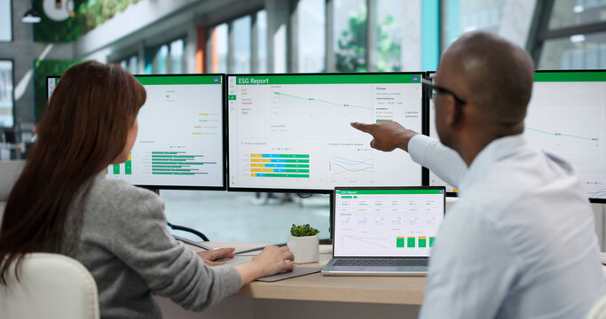 Two Environmental Lawyers And A Scientist Review ESG Report On Computer Screen