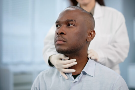 Doctor Gently Examines A Patients Neck, Checking For Thyroid Issues