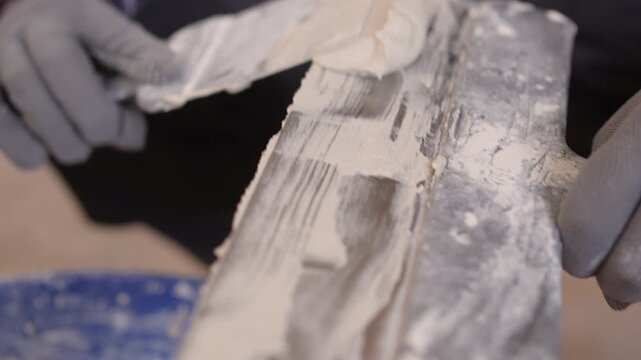 Close-up of Builder with plastering tools indoors for home renovation