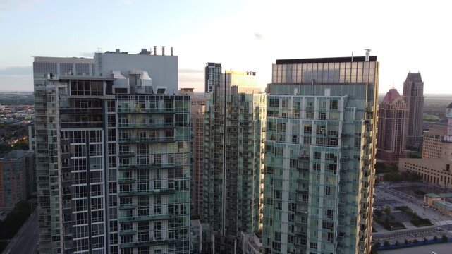 Circling aerial view of the skyscraper condominium buildings in downtown Mississauga, Ontario, Canada. Shot on a beautiful summer late afternoon.