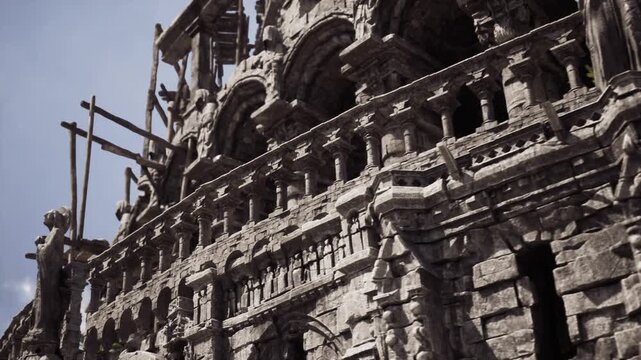 detailed relief and balcony with ornate arches and weathered stone, conservator examining surface for repair, soft sky and contrasty shadow create tactile mood