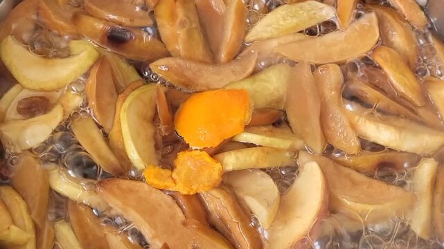 Boiling dried fruit compote in a pot.