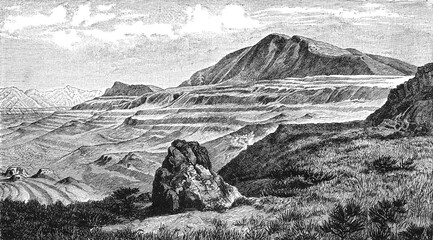 Quaternary beach terraces in Utah, vast mountainous terrain with layered ridges, rocky formations and vegetation in foreground, textured sky, old vintage illustration, 1897. © Timofeeff