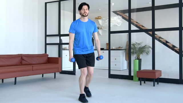 Motivated fitness man in activewear practicing cross weight training, performing dumbbell reverse lunges workout , improving hamstring and glute muscles in domestic room.
