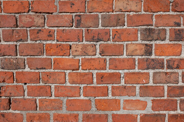 Fototapeta premium Red brick wall texture with varying shades and mortar joints, showcasing a rustic and industrial appearance suitable for backgrounds